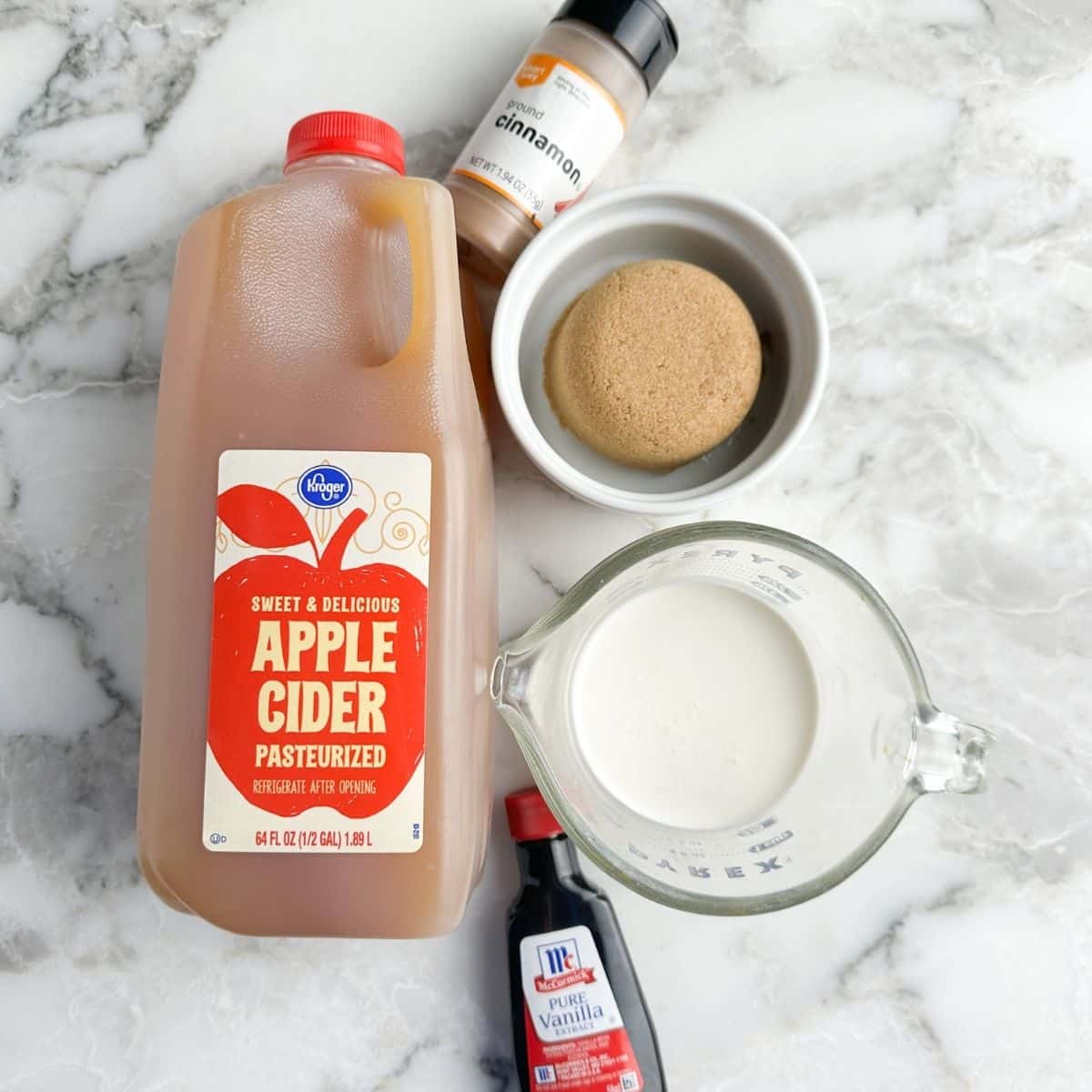 Apple cider, bowl of brown sugar, cinnamon, and milk. 