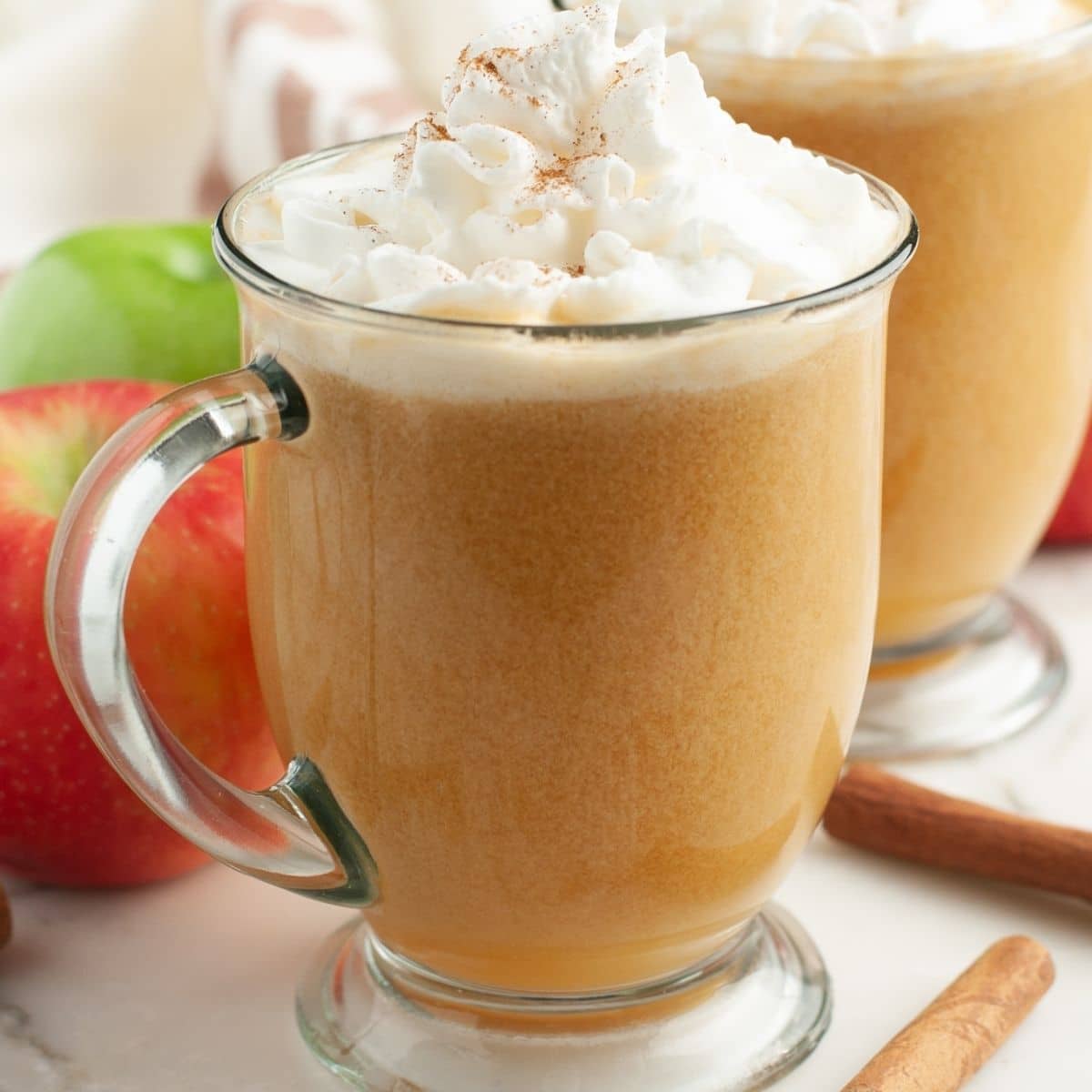 Mug with caramel apple cider and whipped cream. 