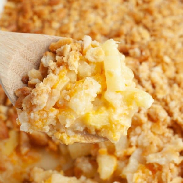 Wooden spoon with pineapple casserole.