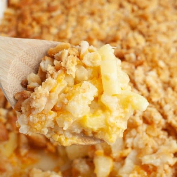 Wooden spoon with pineapple casserole.