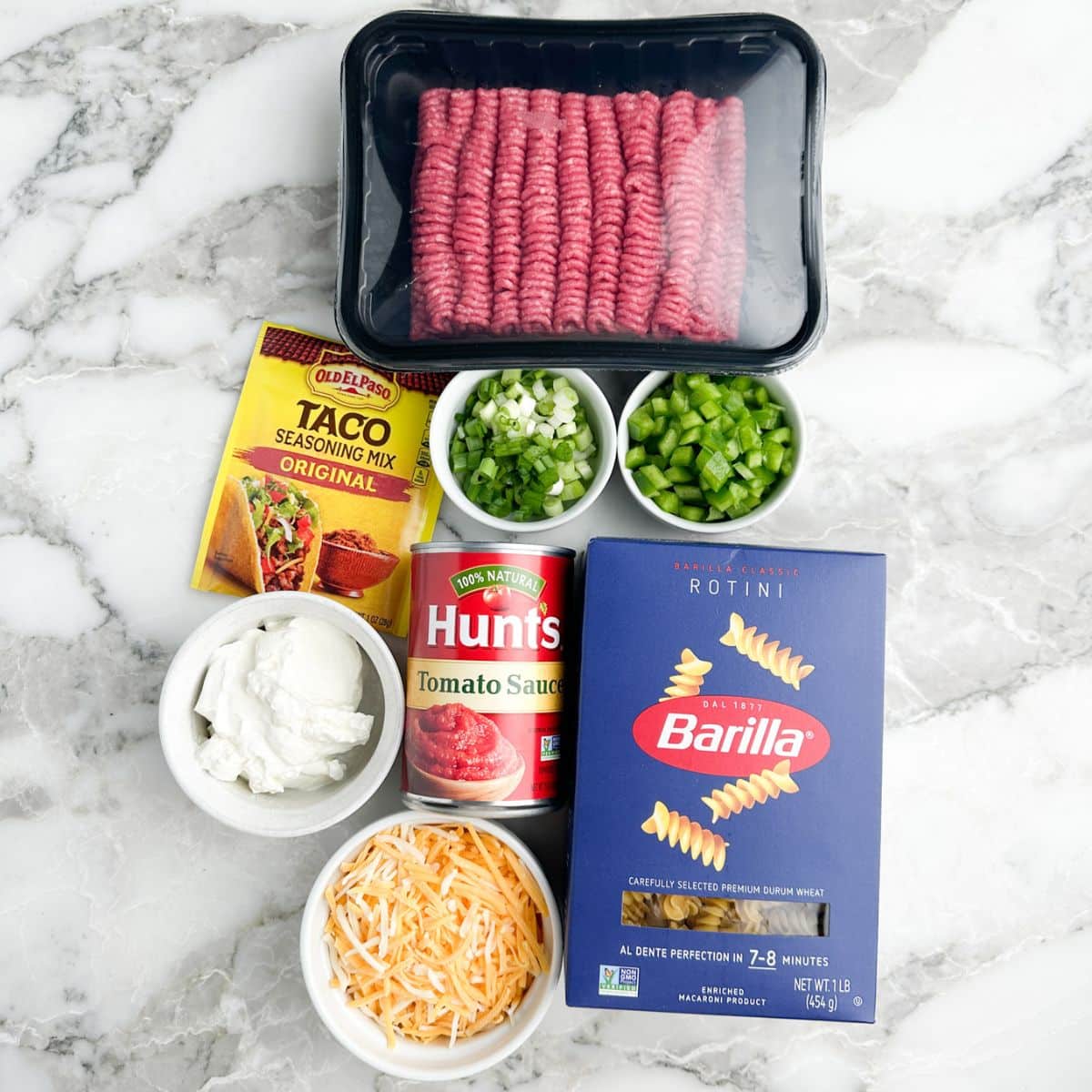 Ground beef, taco seasonings, rotini pasta, sour cream, and cheese. 