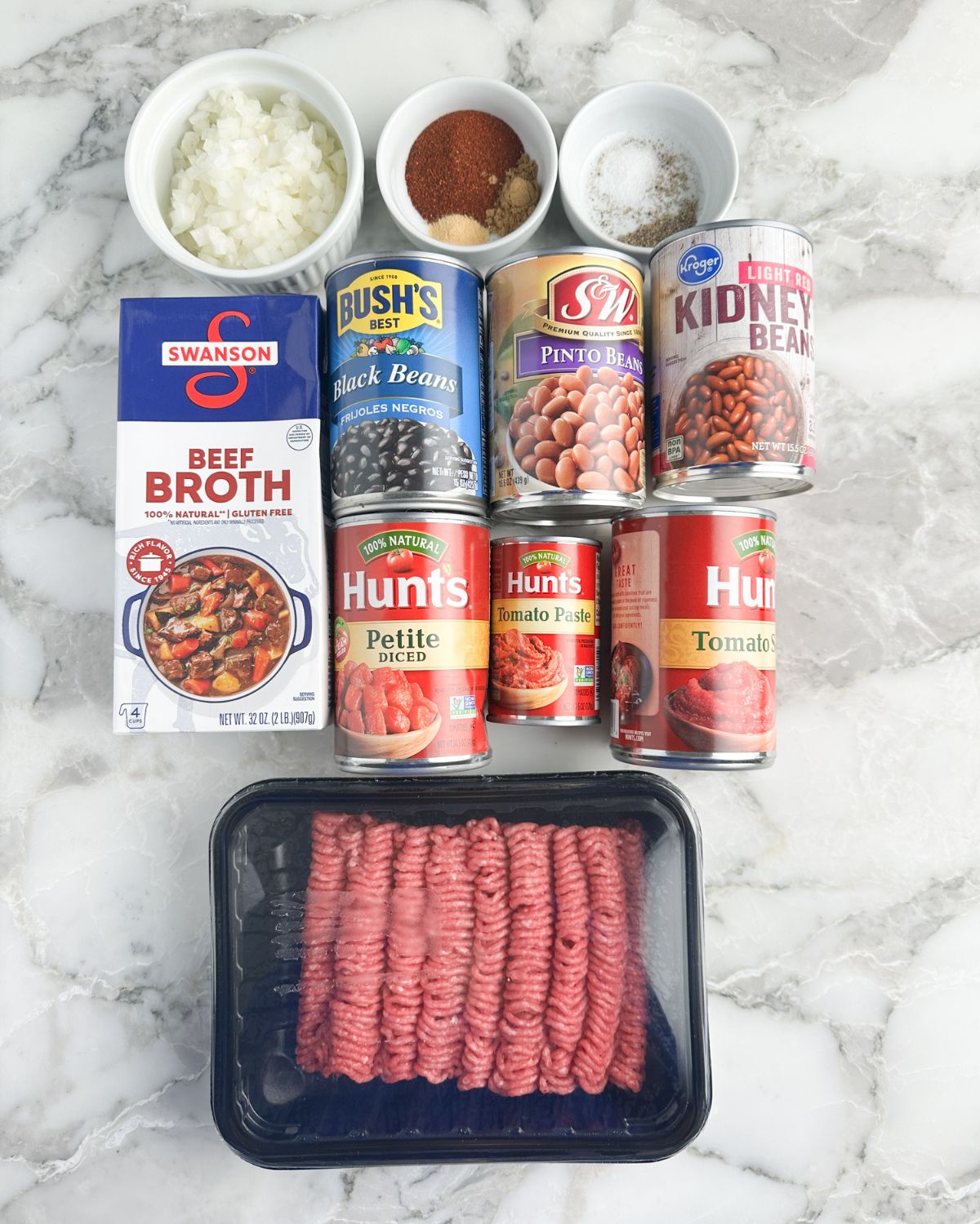 Ground beef, cans of beans, beef broth, spices, and diced onions. 