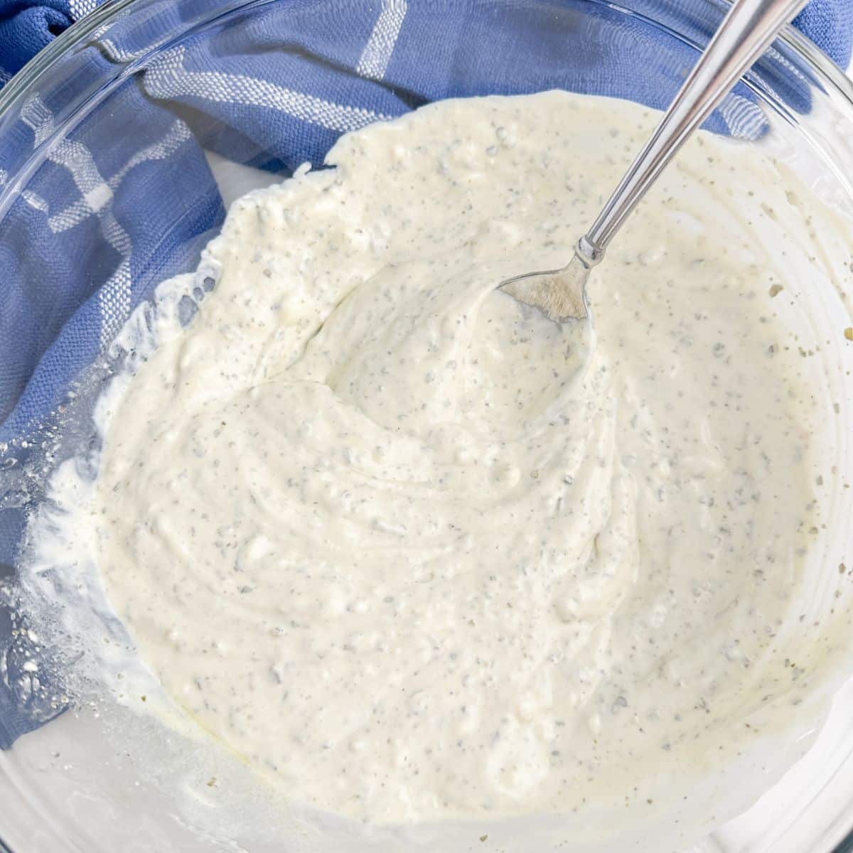 Bowl of creamy dip with a spoon. 