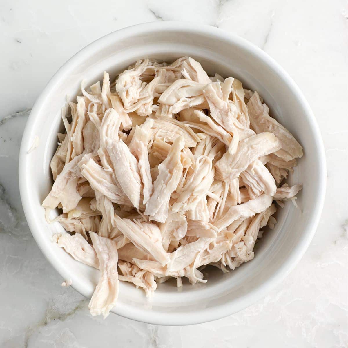 Bowl with shredded chicken.