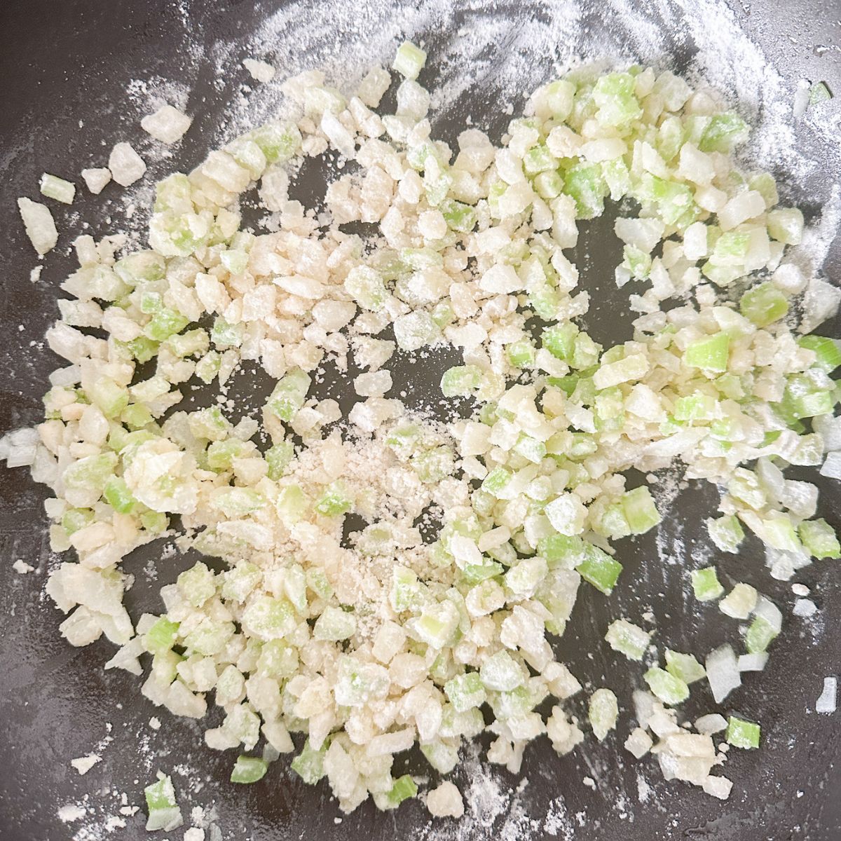 Skillet with onions, celery, and flour.