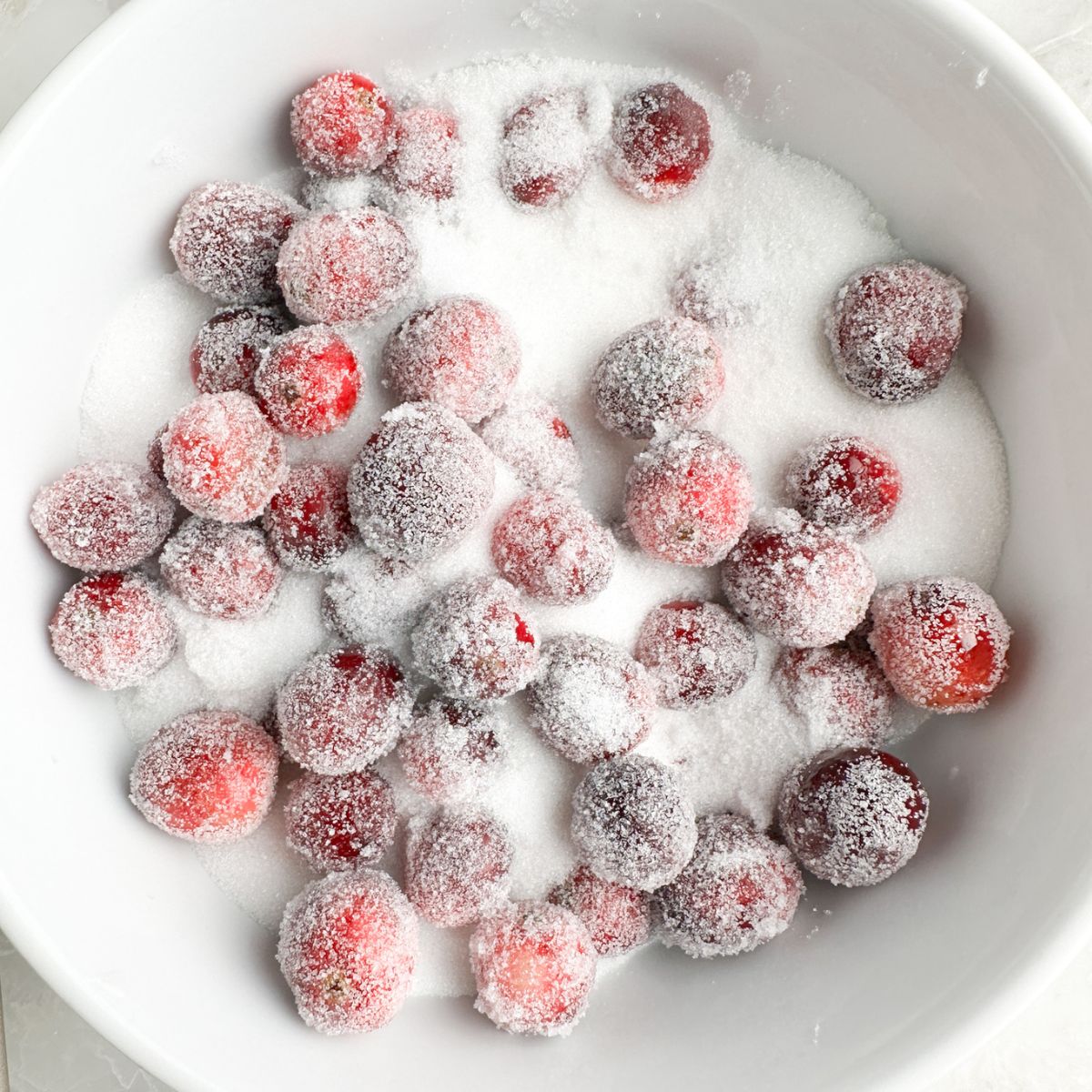 Bowl with sugar and cranberries. 