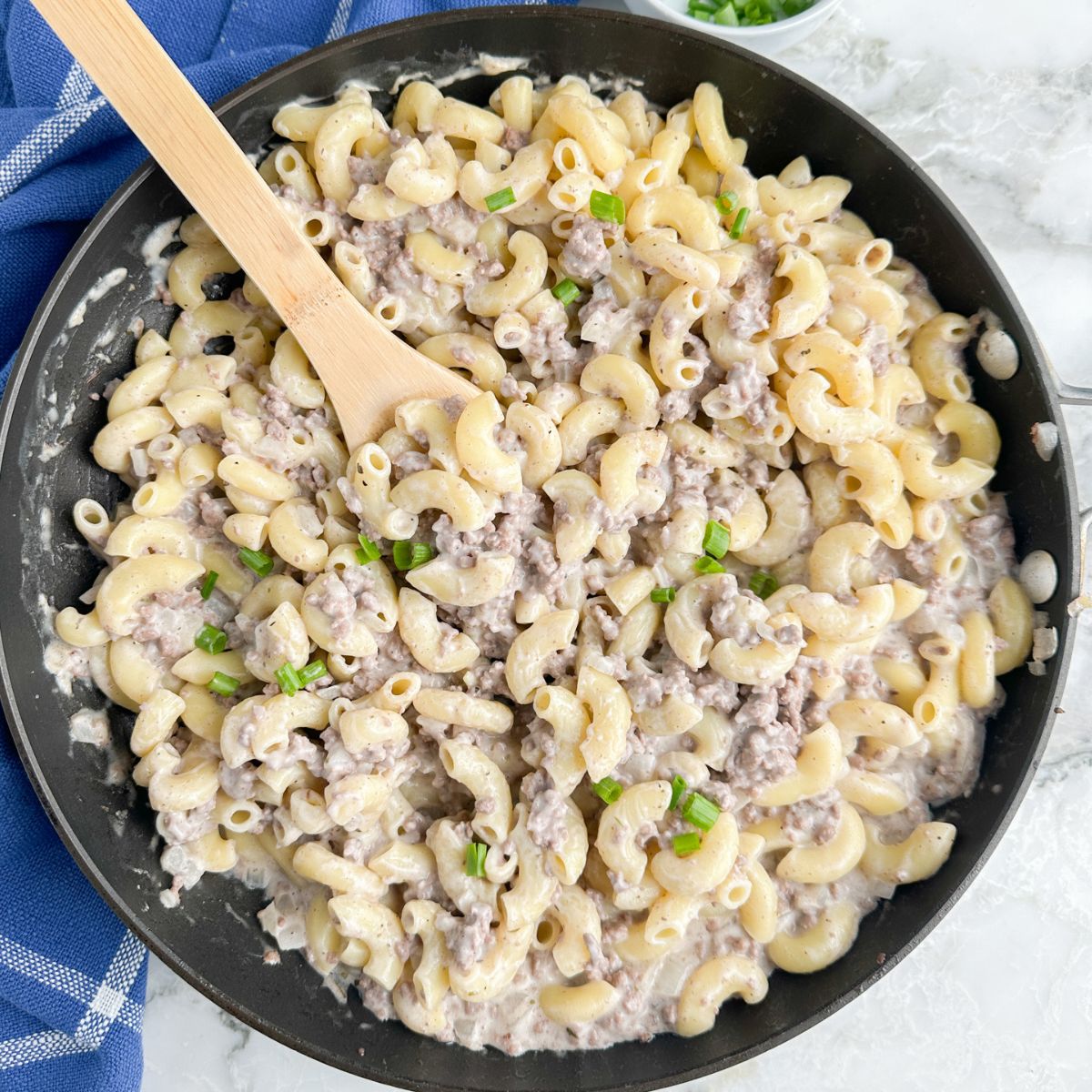 Skillet with pasta, ground beef, and cream sauce.