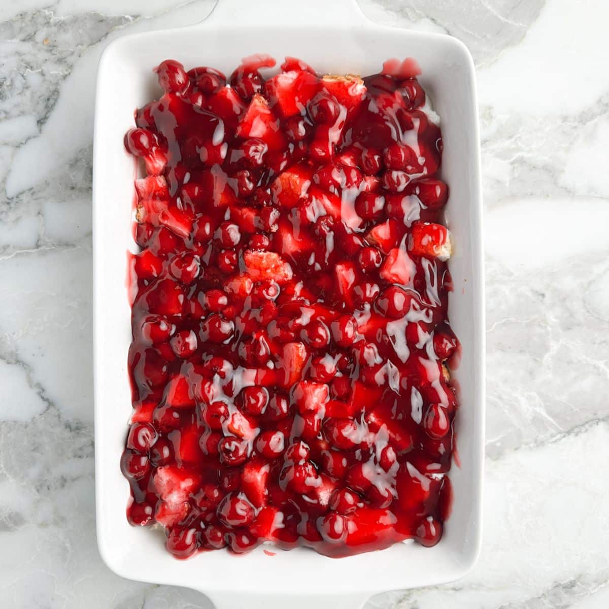 Baking dish with cherry pie filling. 