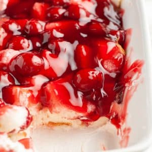 Baking dish with a creamy cherry dessert.