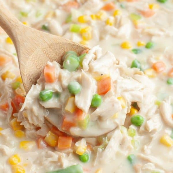 Wooden spoon with chicken and vegetables.