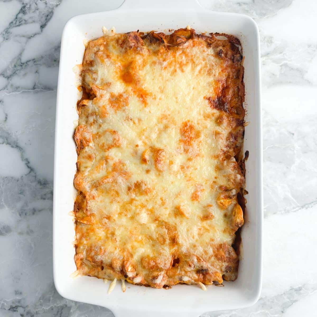 Baked tortellini casserole in a baking dish.