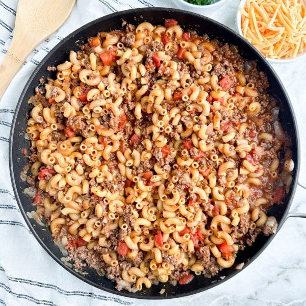 Skillet with ground beef, tomatoes, and macaroni.