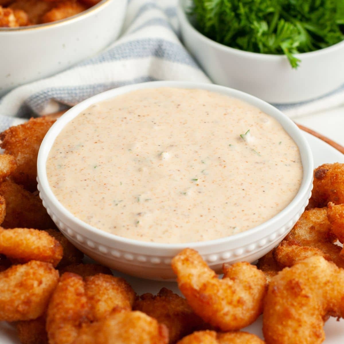 Bowl of remoulade sauce with fried shrimp. 