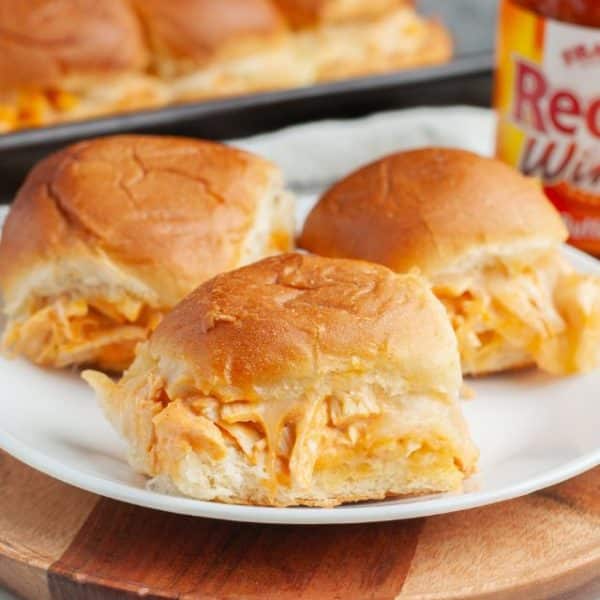 3 buffalo chicken sliders on a plate.