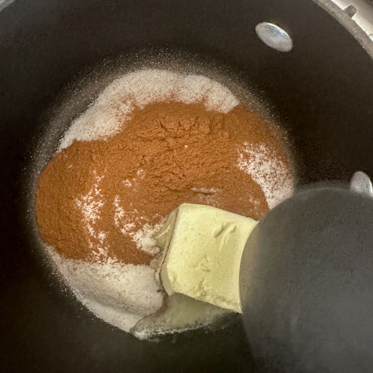 Pot with butter, sugar, and cinnamon. 