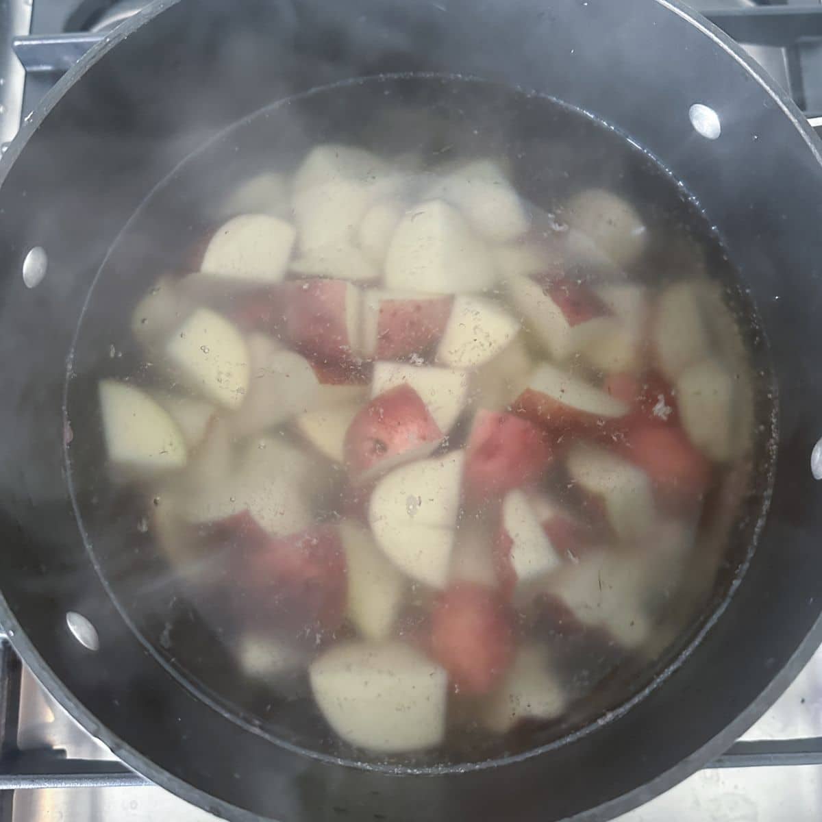 Pot with cubed red skin potatoes.
