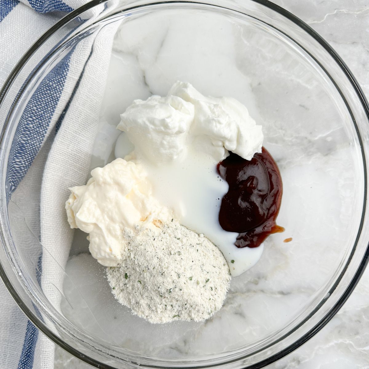 Bowl with BBQ sauce, sour cream, ranch seasonings, and mayo. 