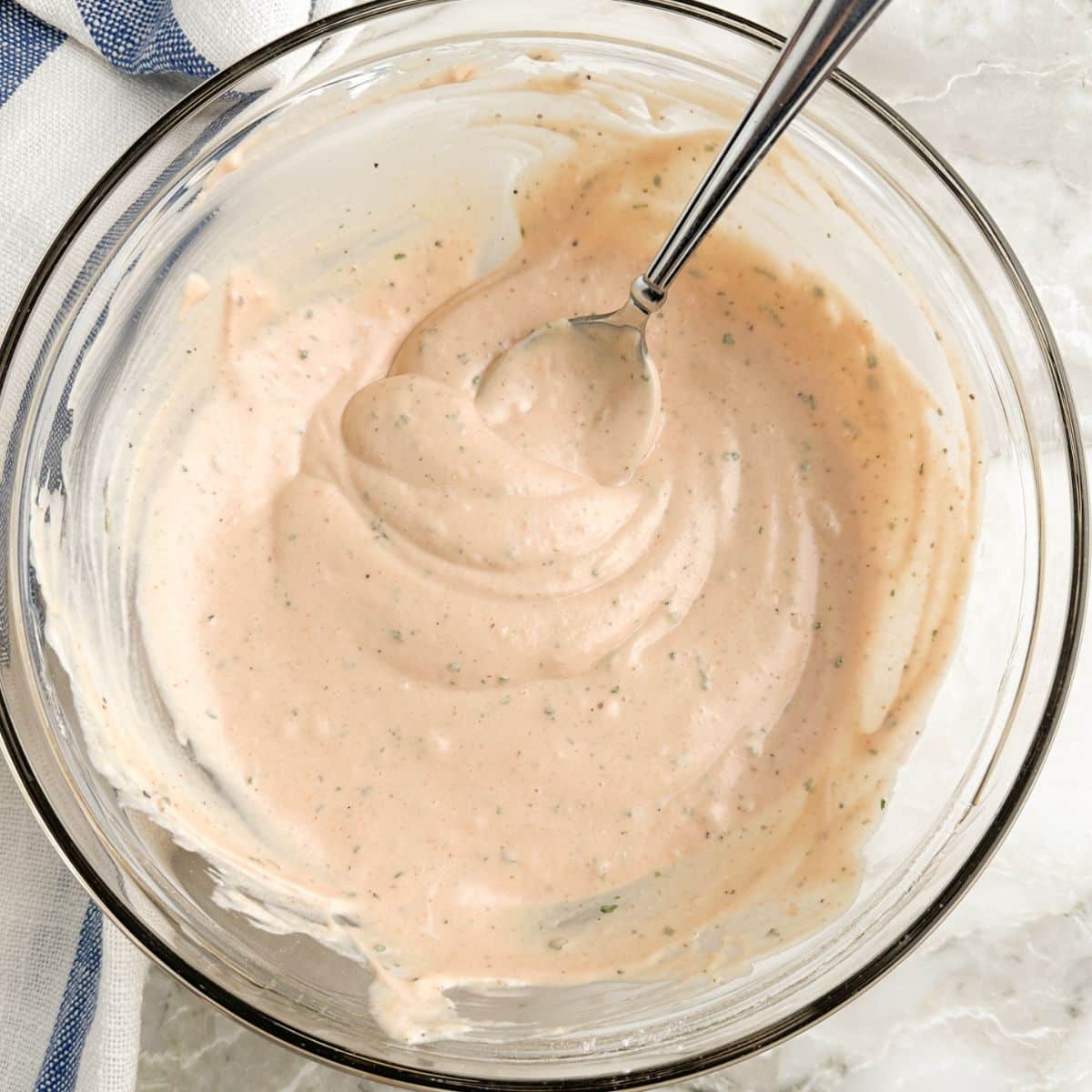 Bowl of BBQ ranch dip and a spoon. 