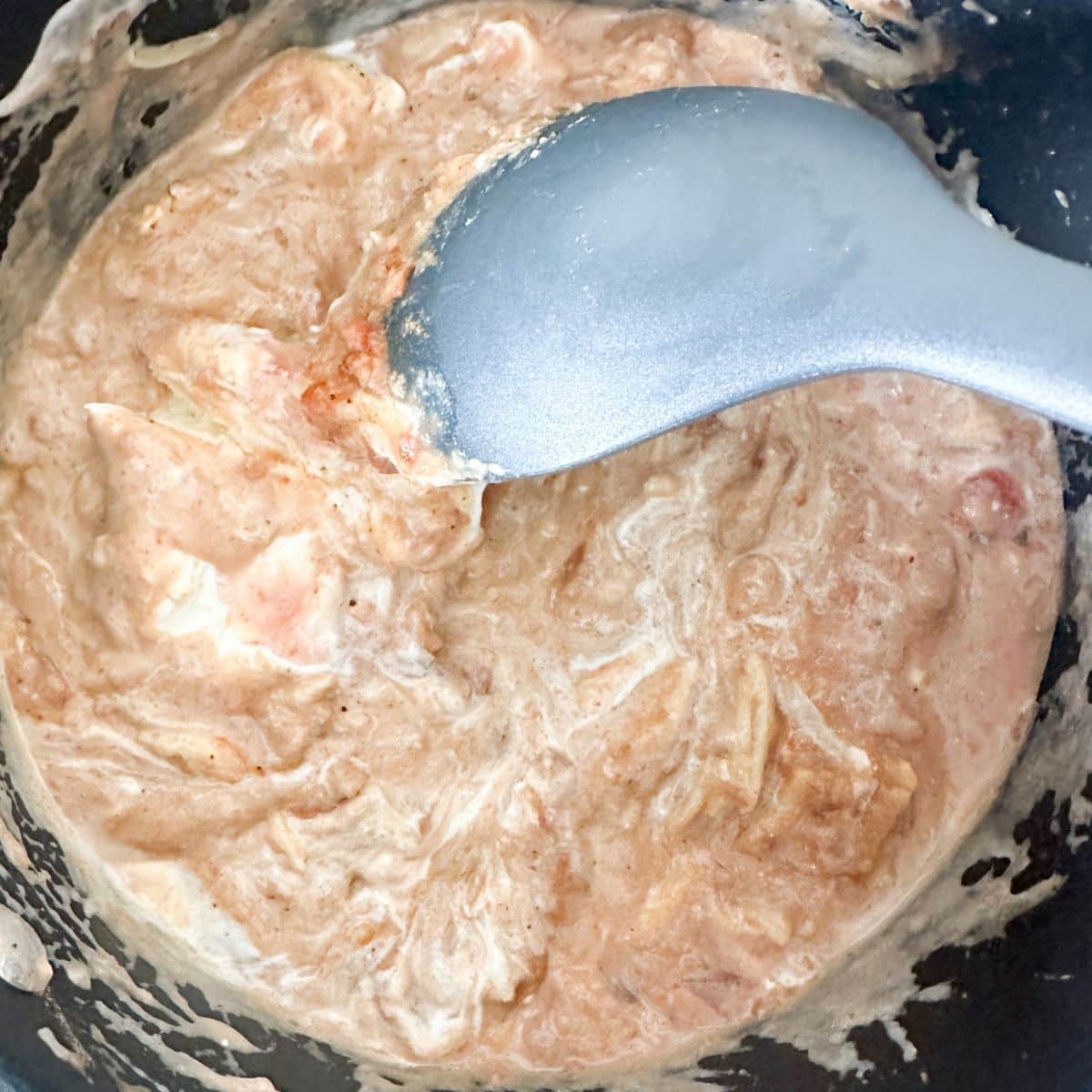 Pot with refried beans and sour cream.