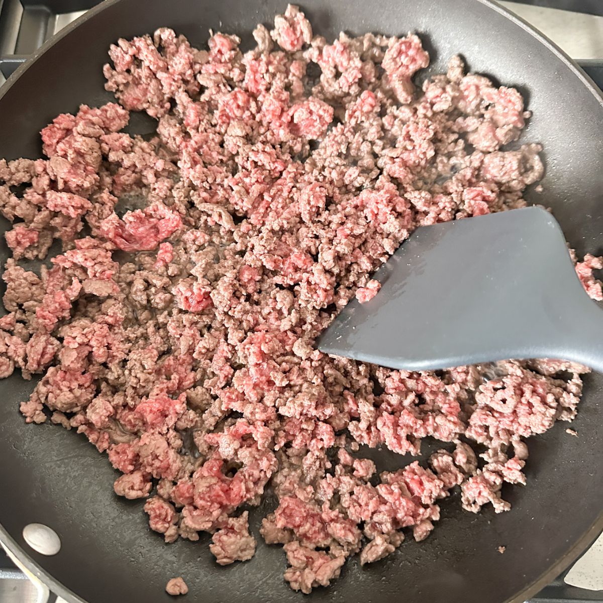 Skillet with ground beef. 