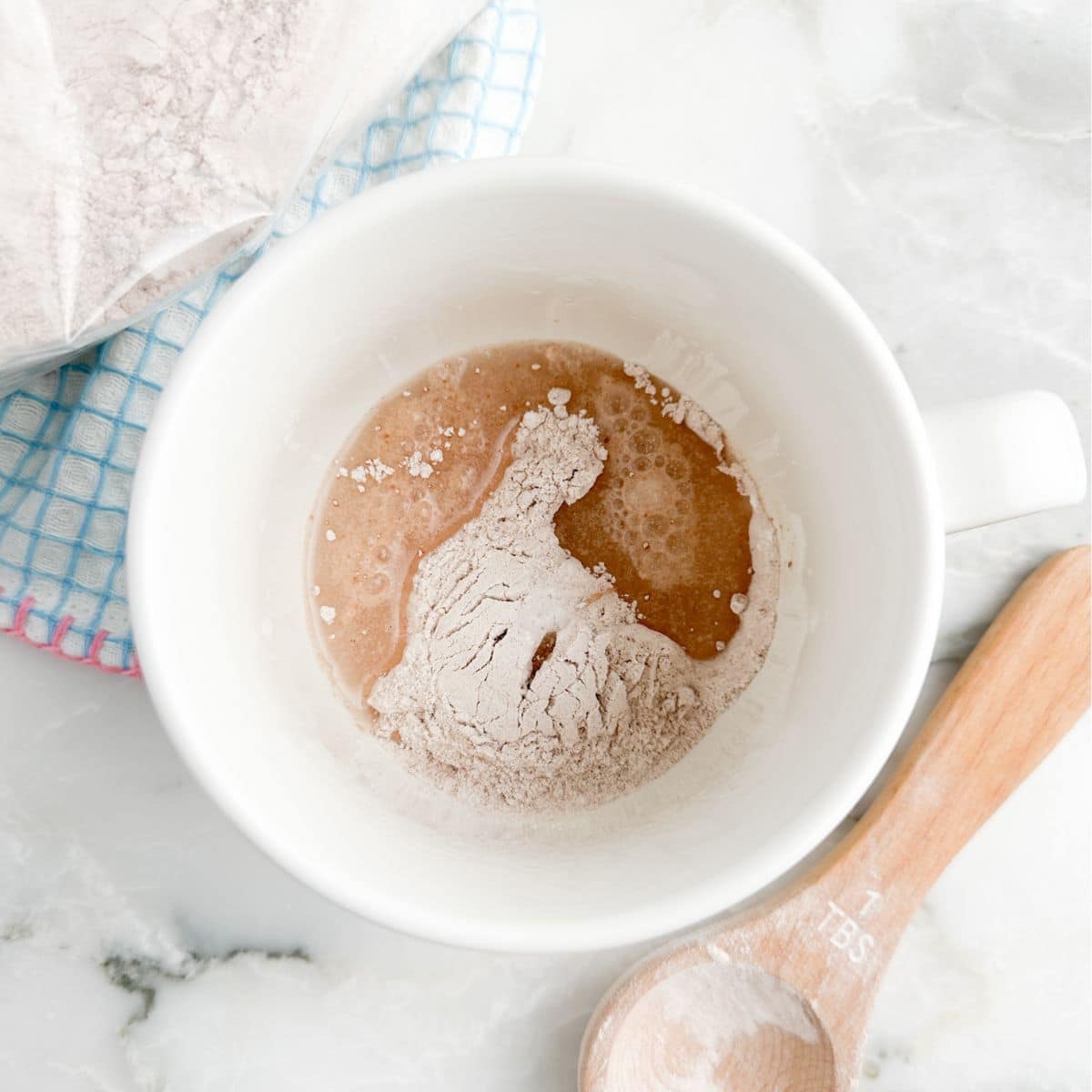 Mug with cake mix and water. 