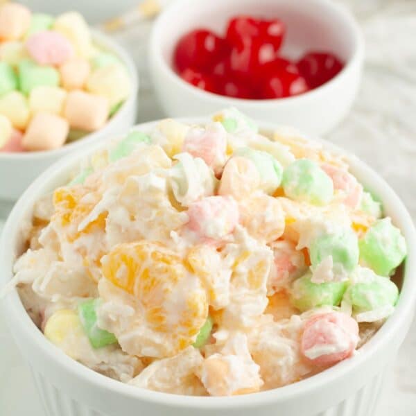 Bowl of fruit salad with colorful marshmallows.