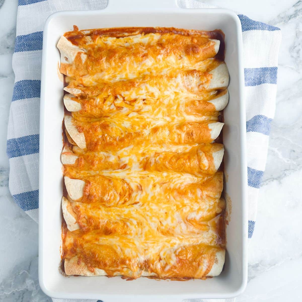 Casserole dish with cooked enchiladas. 