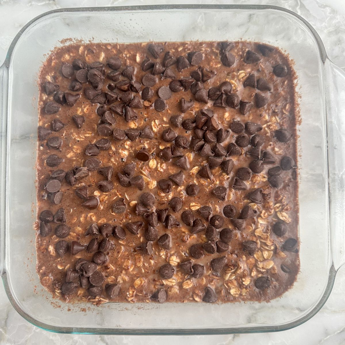 Baked oatmeal with chocolate chips in a baking dish. 