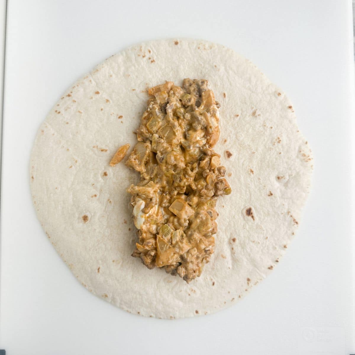 Flour tortilla with beef mixture down the center. 
