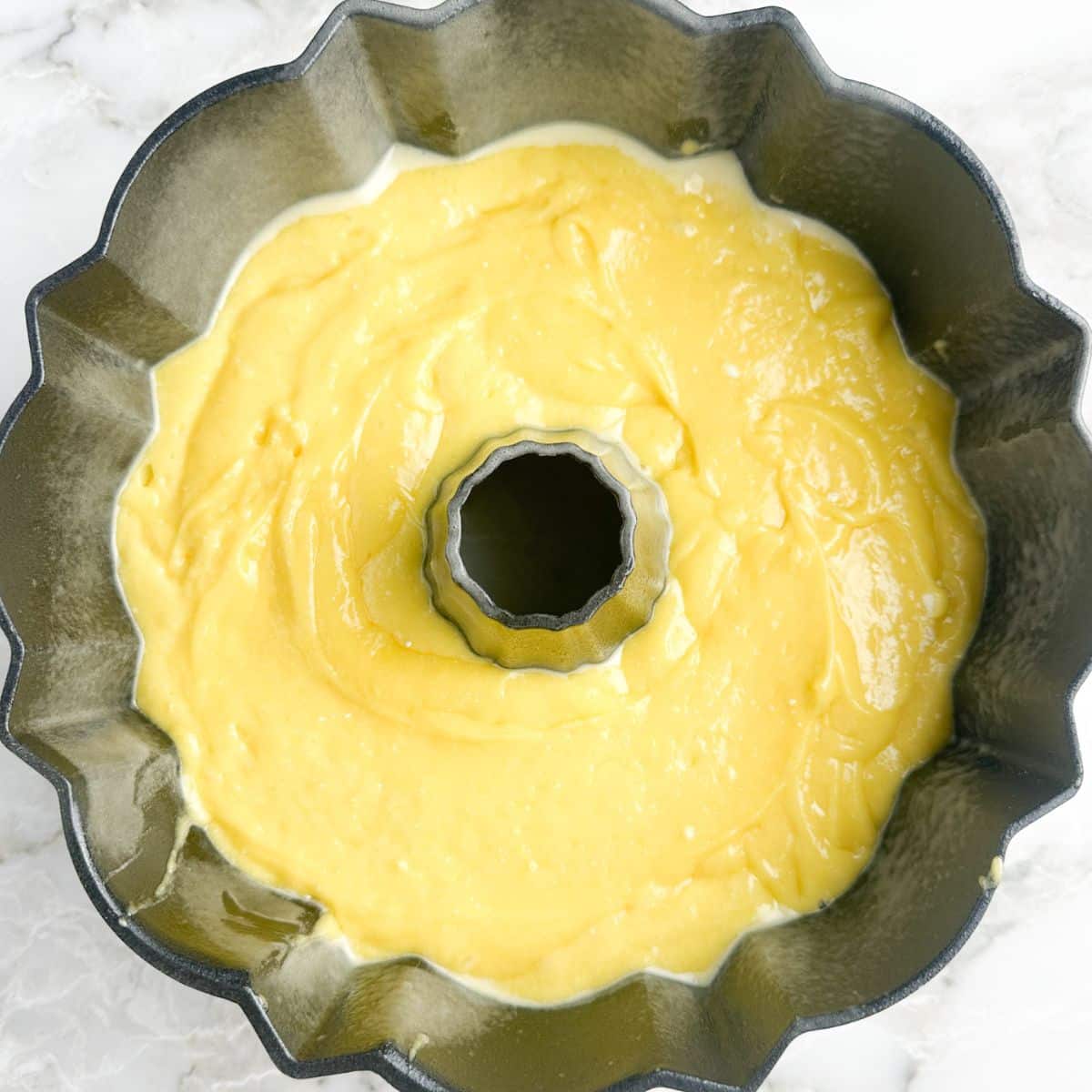 Bundt cake pan with lemon cake batter. 