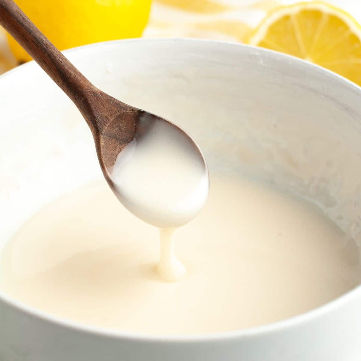 Bowl with wooden spoon and lemon glaze. 