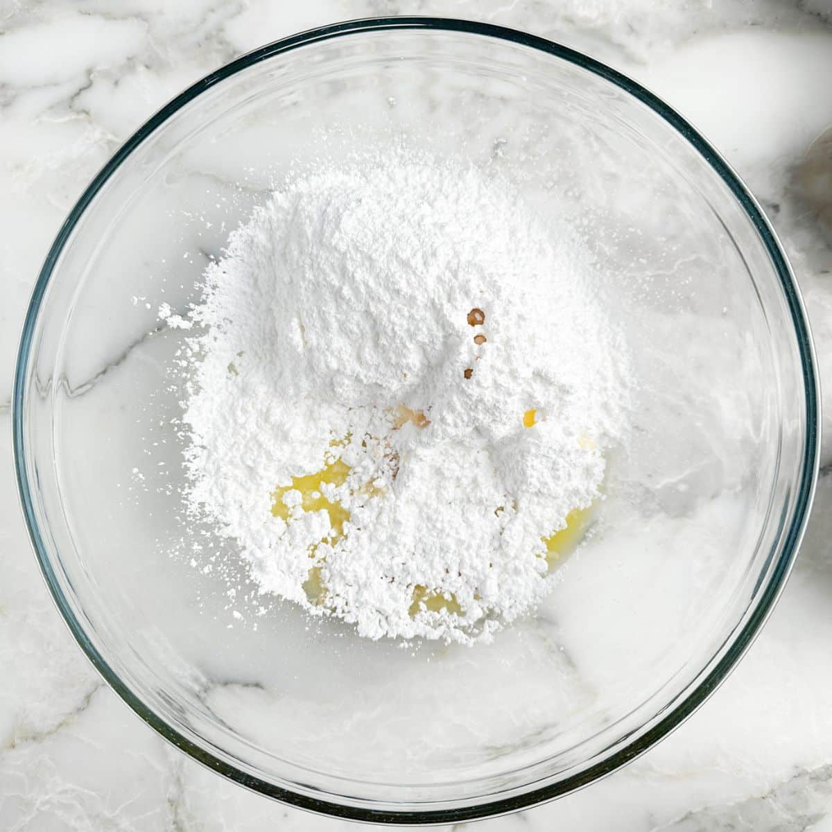 Bowl of powdered sugar and orange juice. 