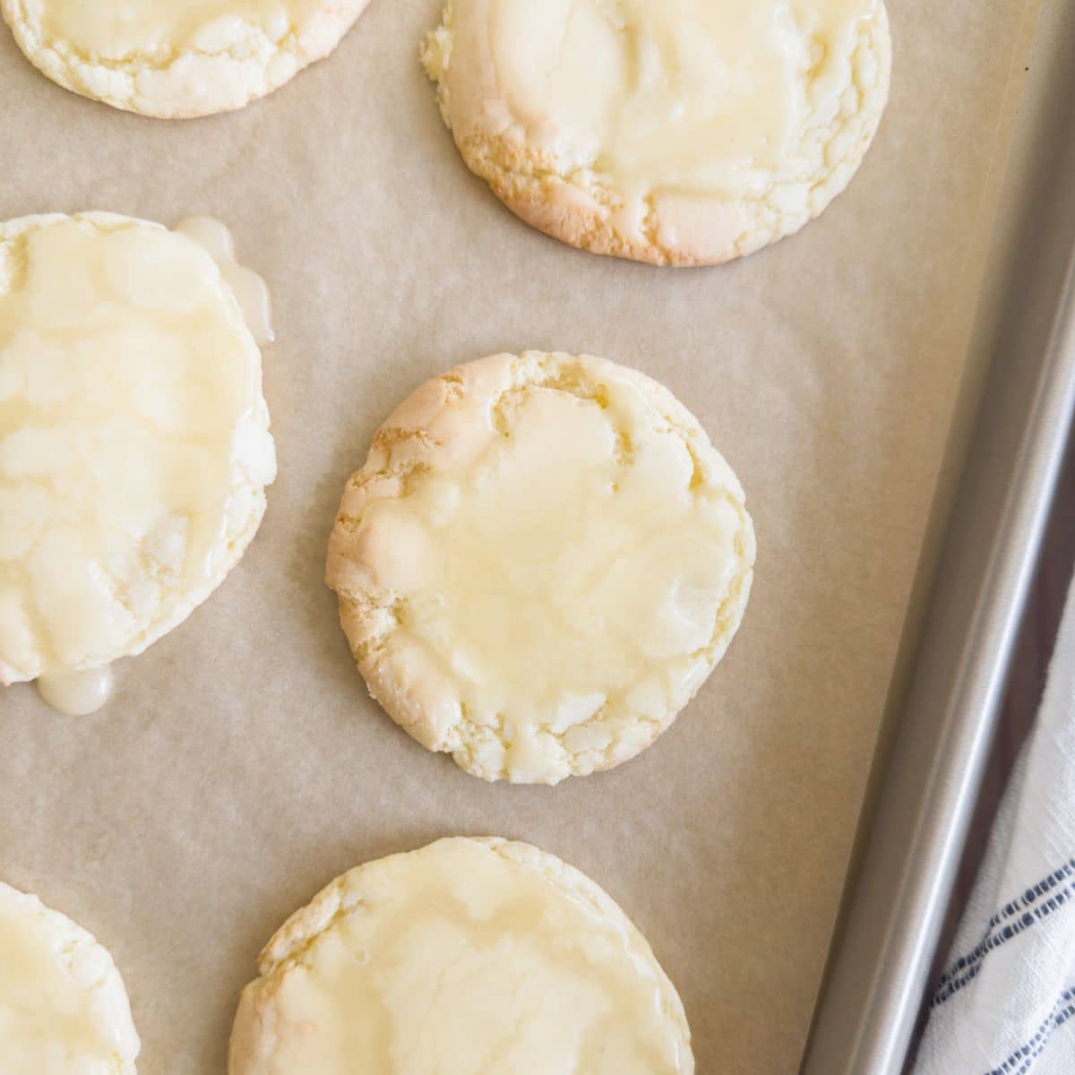 Butter cookies with icing on a cookie sheet. 
