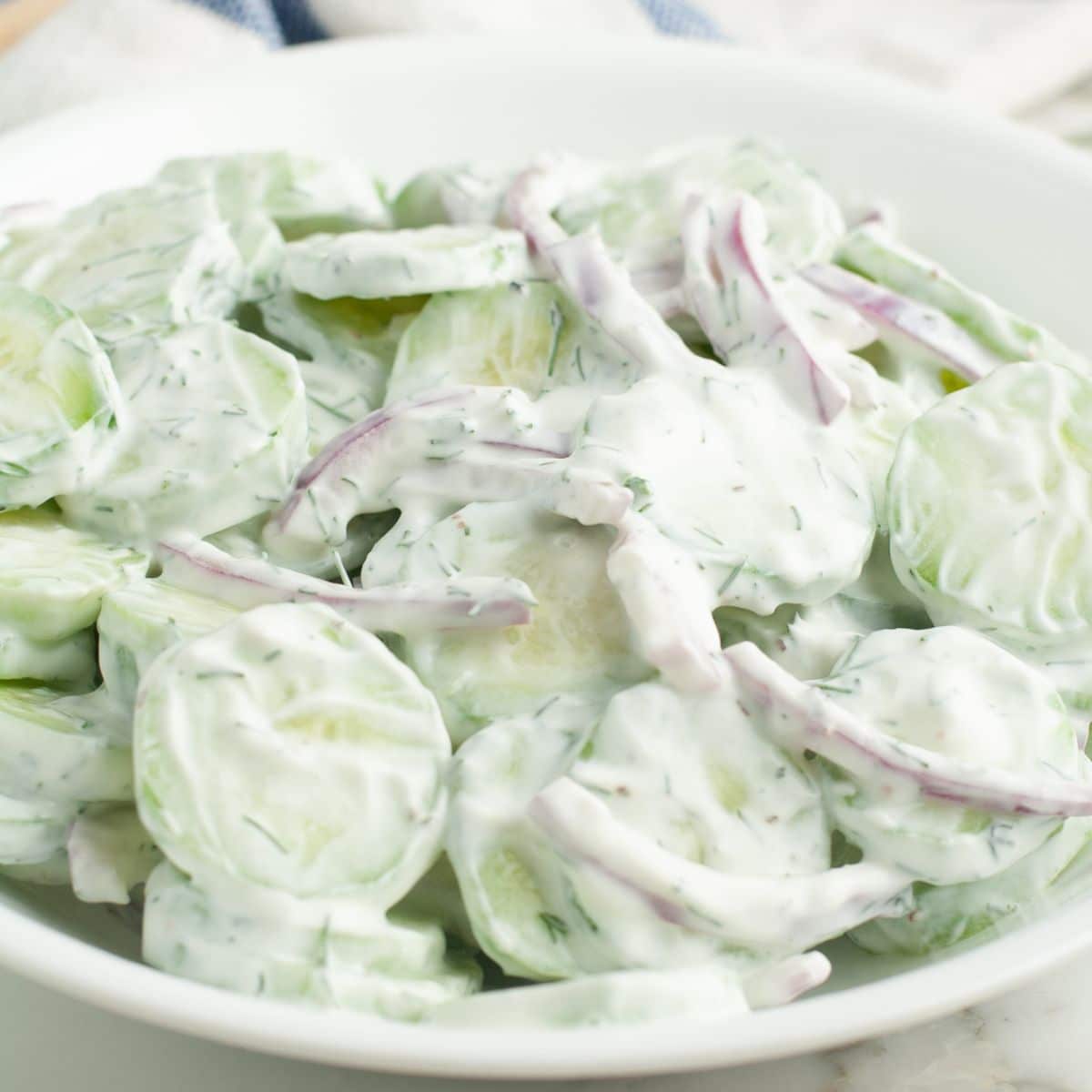 Bowl with cucumber onion salad.