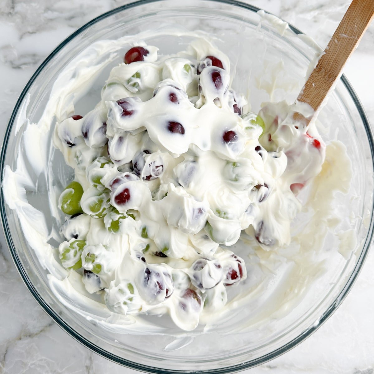 Bowl of grapes covered in cream. 