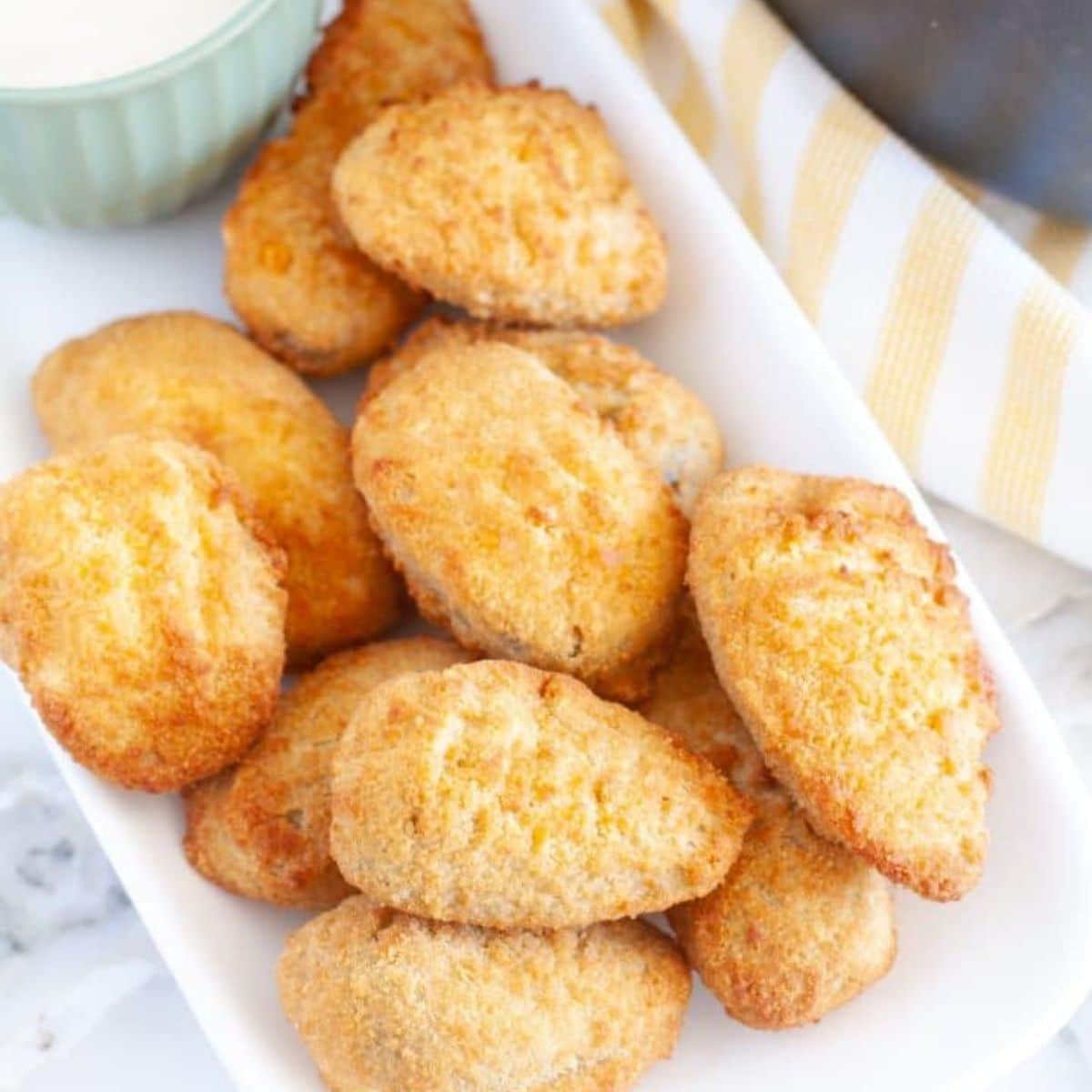 Fried jalapeno poppers on a plate.