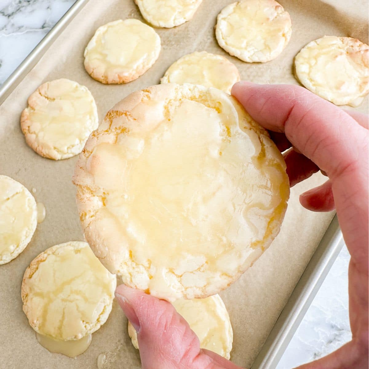 Hand holding a butter cookie with icing. 