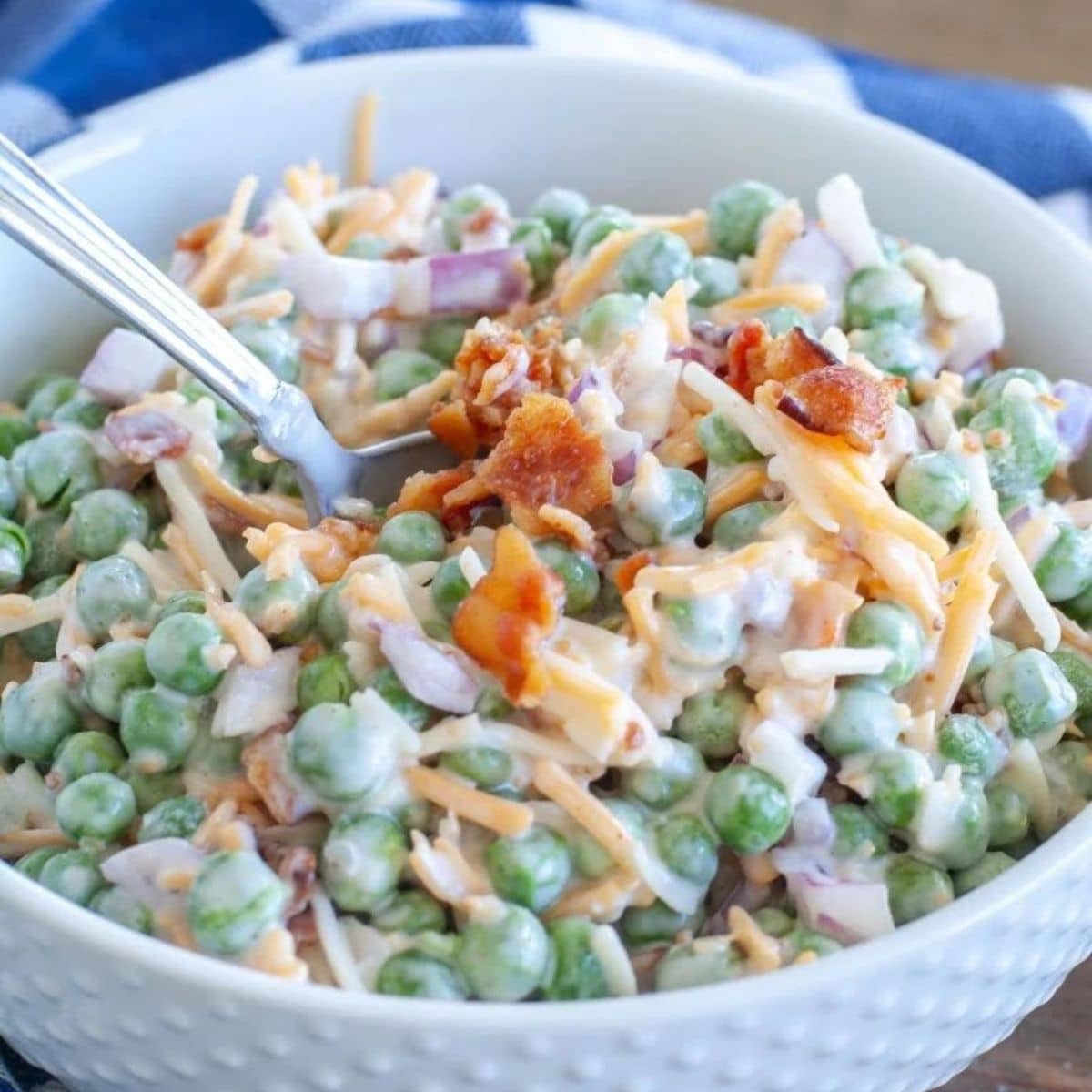 Bowl of pea salad with chopped bacon.
