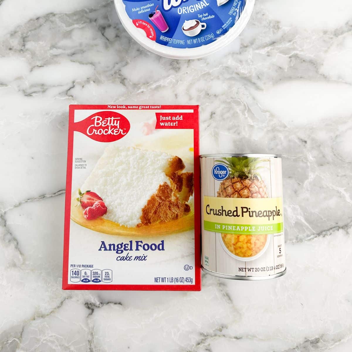 Box of angel food cake mix, can of crushed pineapple, and Cool Whip.