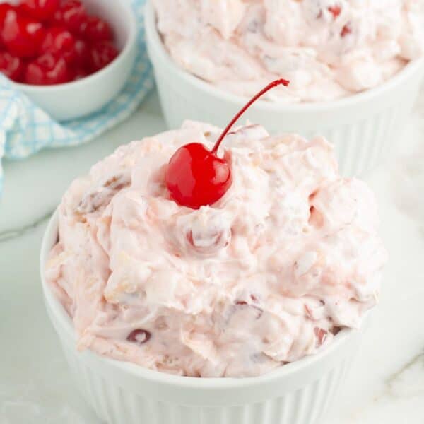 Bowl of cherry fluff topped with a cherry.