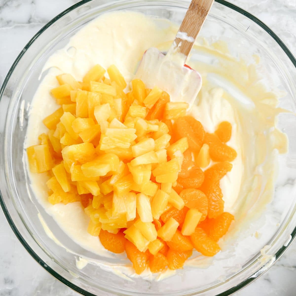 Bowl with pudding, pineapple, and mandarin oranges. 