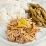 Plate with shredded Mississippi chicken, rice, and beans.