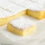 Lemon bars on parchment paper.
