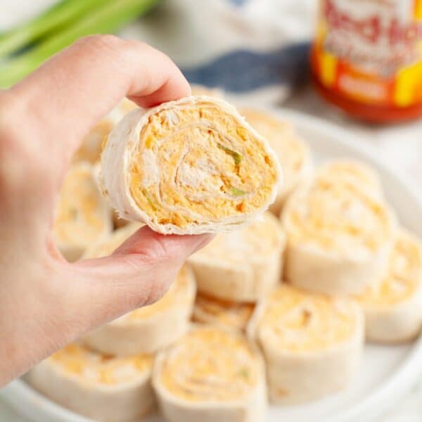 Hand holding a buffalo chicken pinwheel.
