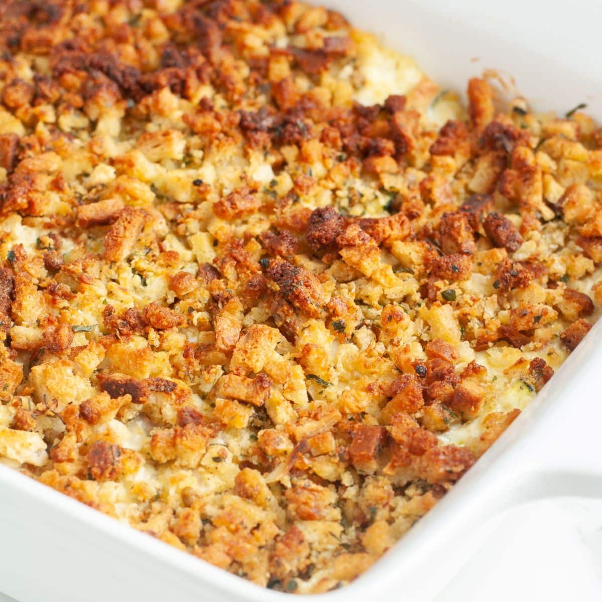Cheesy chicken zucchini squash casserole in baking dish.