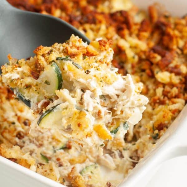 Spoon scooping out chicken zucchini squash casserole.