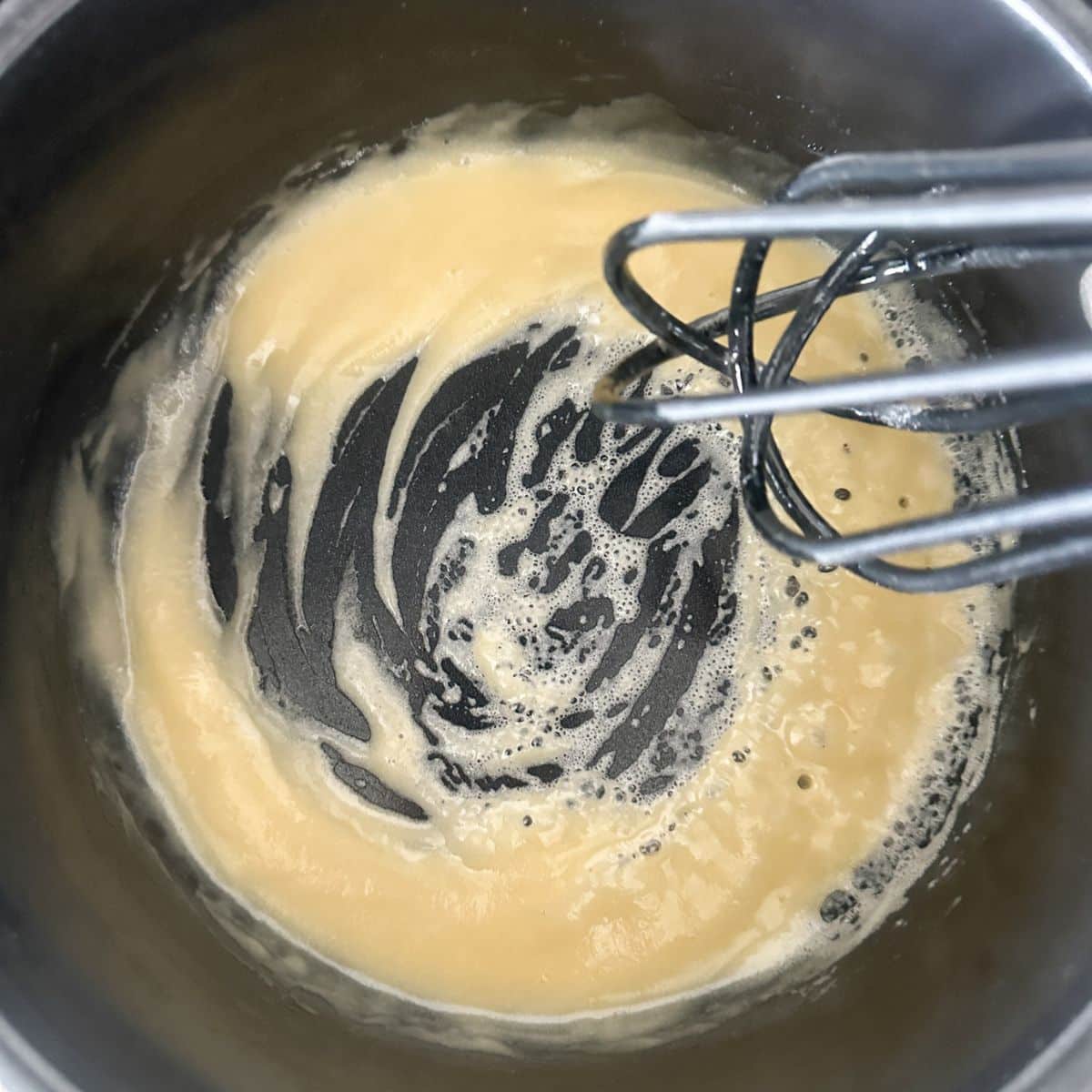 Saucepan with a roux and whisk.