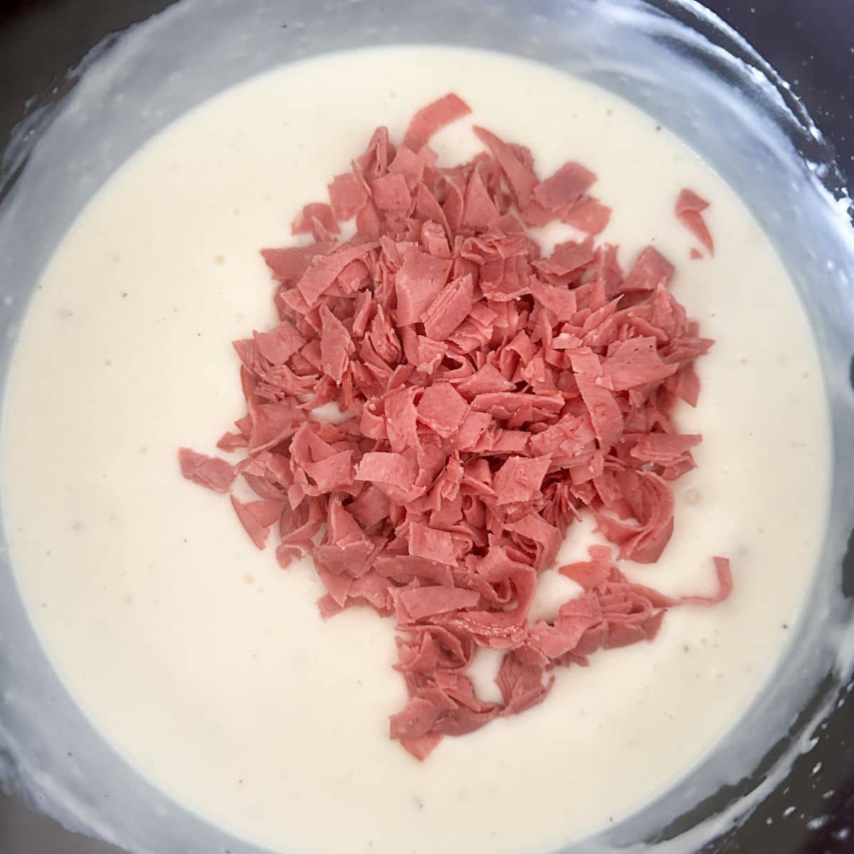 Saucepan with gravy and diced chipped beef.