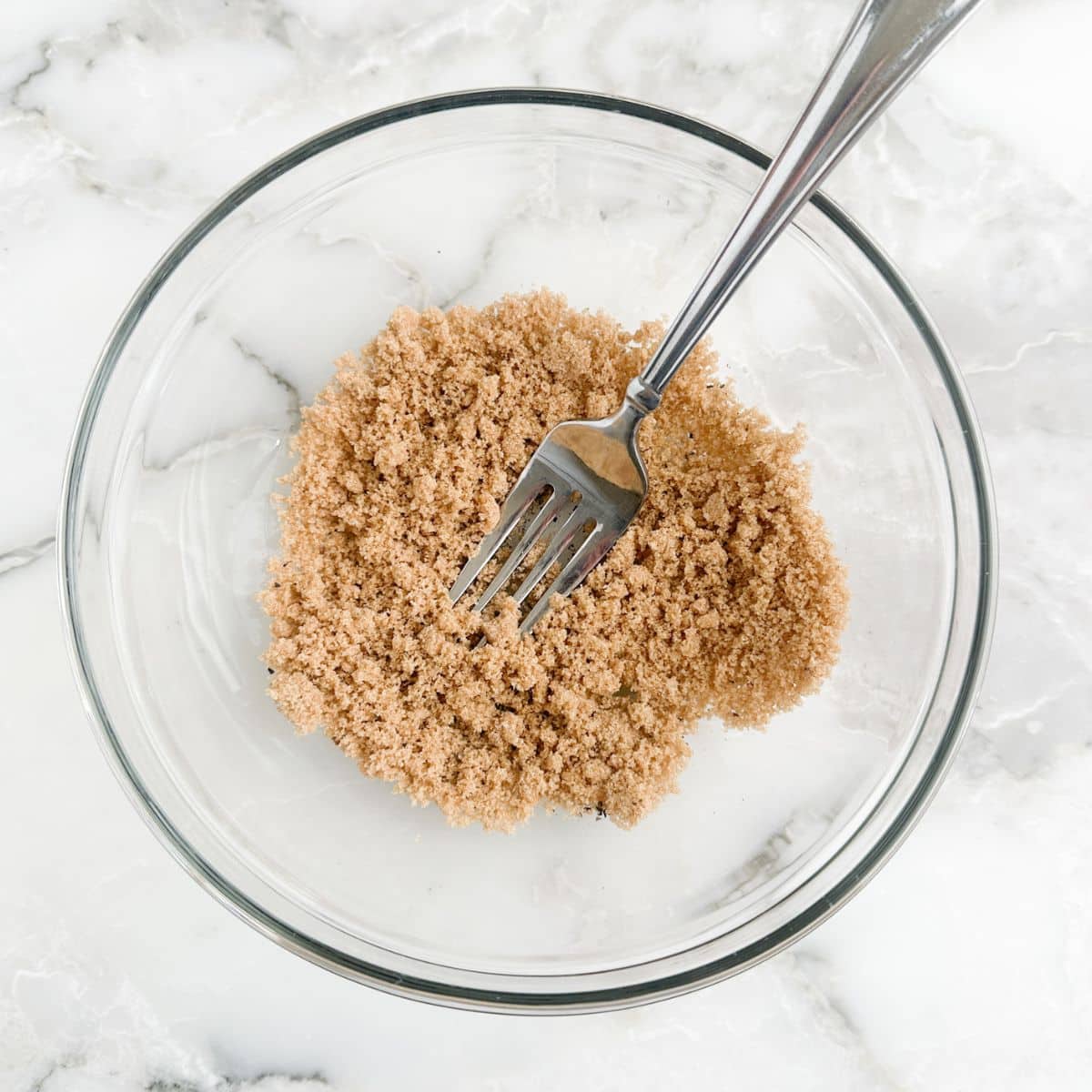 Bowl of brown sugar with a fork.