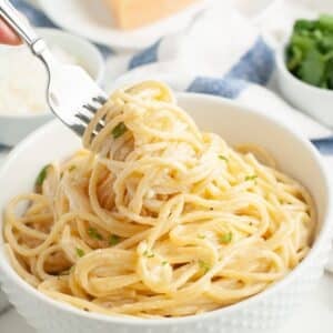 Bowl of spaghetti alfredo with a fork.